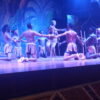 Vibrant night performance at Safari Cat Show in Nairobi, showcasing traditional African dance and cultural entertainment under colorful stage lighting.