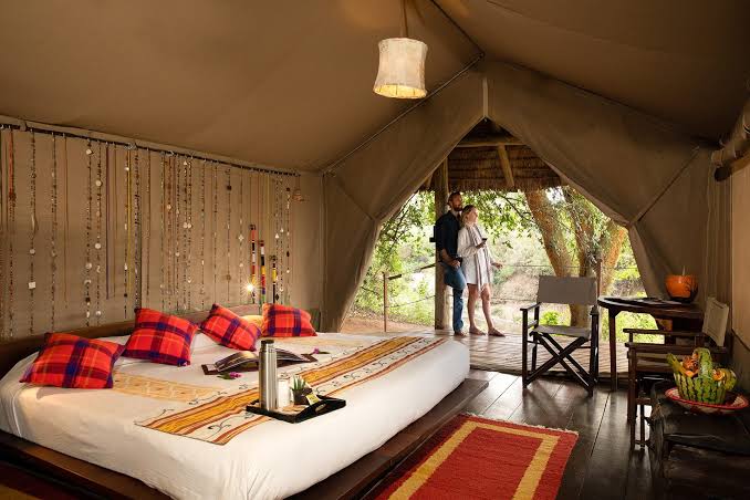 Luxury safari tent for couples in Maasai Mara with a king-size bed, private deck, and scenic bush views during a Kenya safari with Cruzeiro Safaris Kenya.