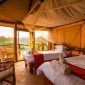 Luxury family safari tent with twin beds, private veranda, and panoramic views of the Maasai Mara at Sentrim Mara Camp, Kenya, offered by Cruzeiro Safaris Kenya.