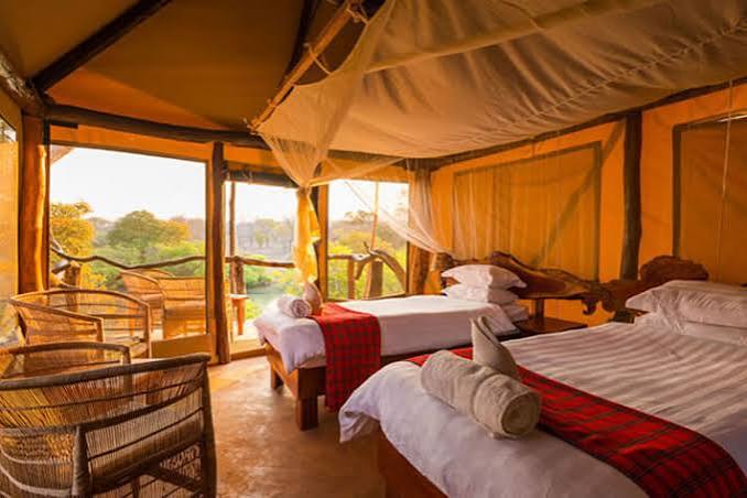 Luxury family safari tent with twin beds, private veranda, and panoramic views of the Maasai Mara at Sentrim Mara Camp, Kenya, offered by Cruzeiro Safaris Kenya.