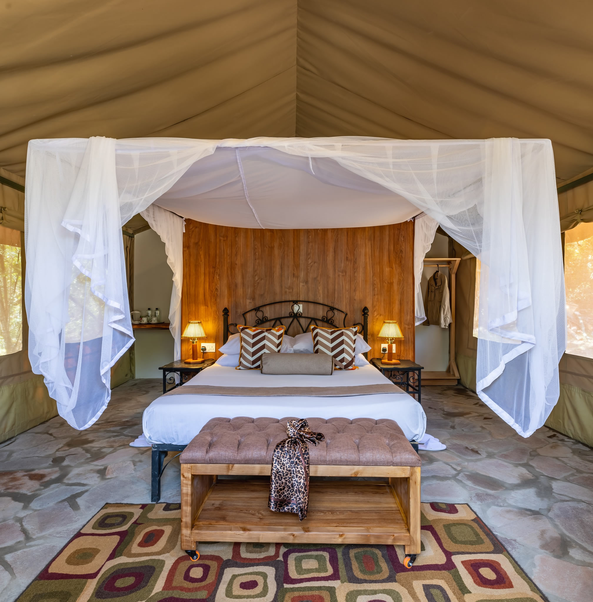 Luxury safari tent with a king-size canopy bed, mosquito net, elegant furnishings, and modern amenities at Sentrim Mara Camp in Maasai Mara, Kenya, offered by Cruzeiro Safaris Kenya.