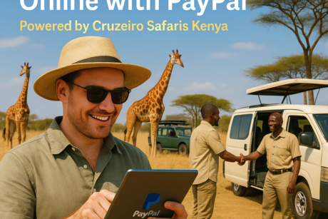 Smiling tourist using a tablet with PayPal logo to book a safari, with giraffes and safari guides in Nairobi National Park; Cruzeiro Safaris van in the background.