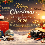 Christmas and New Year 2026 greeting banner by Cruzeiro Safaris featuring a festive travel theme with holiday lights, suitcase, passport, and tropical snow globe.