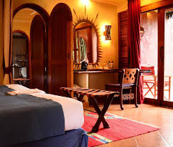 Luxury double room at Amboseli Serena Safari Lodge decorated in elegant safari style with handcrafted furnishings and warm earthy tones.